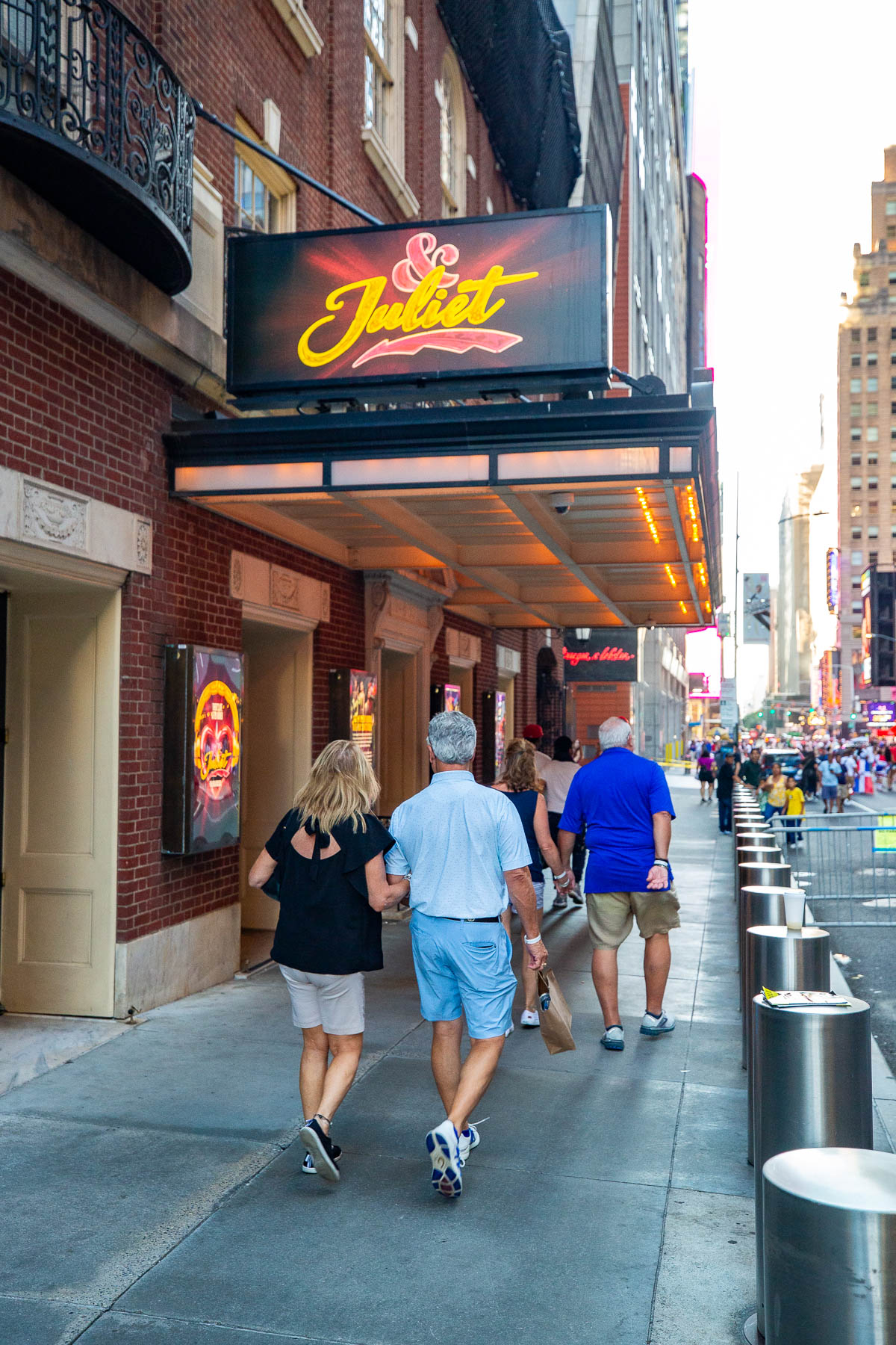 People walking in front of & Juliet at Stephen Sondheim theater, best shows on Broadway for kids