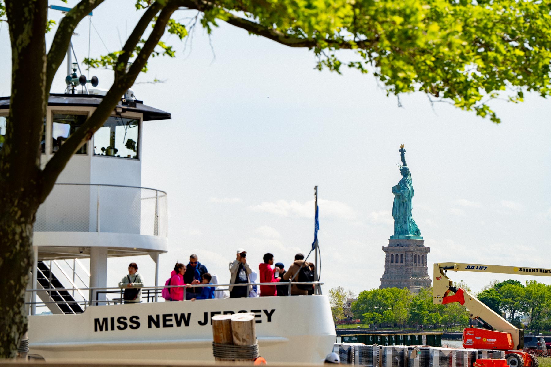 People on ferry with Statue of Liberty in the background, 