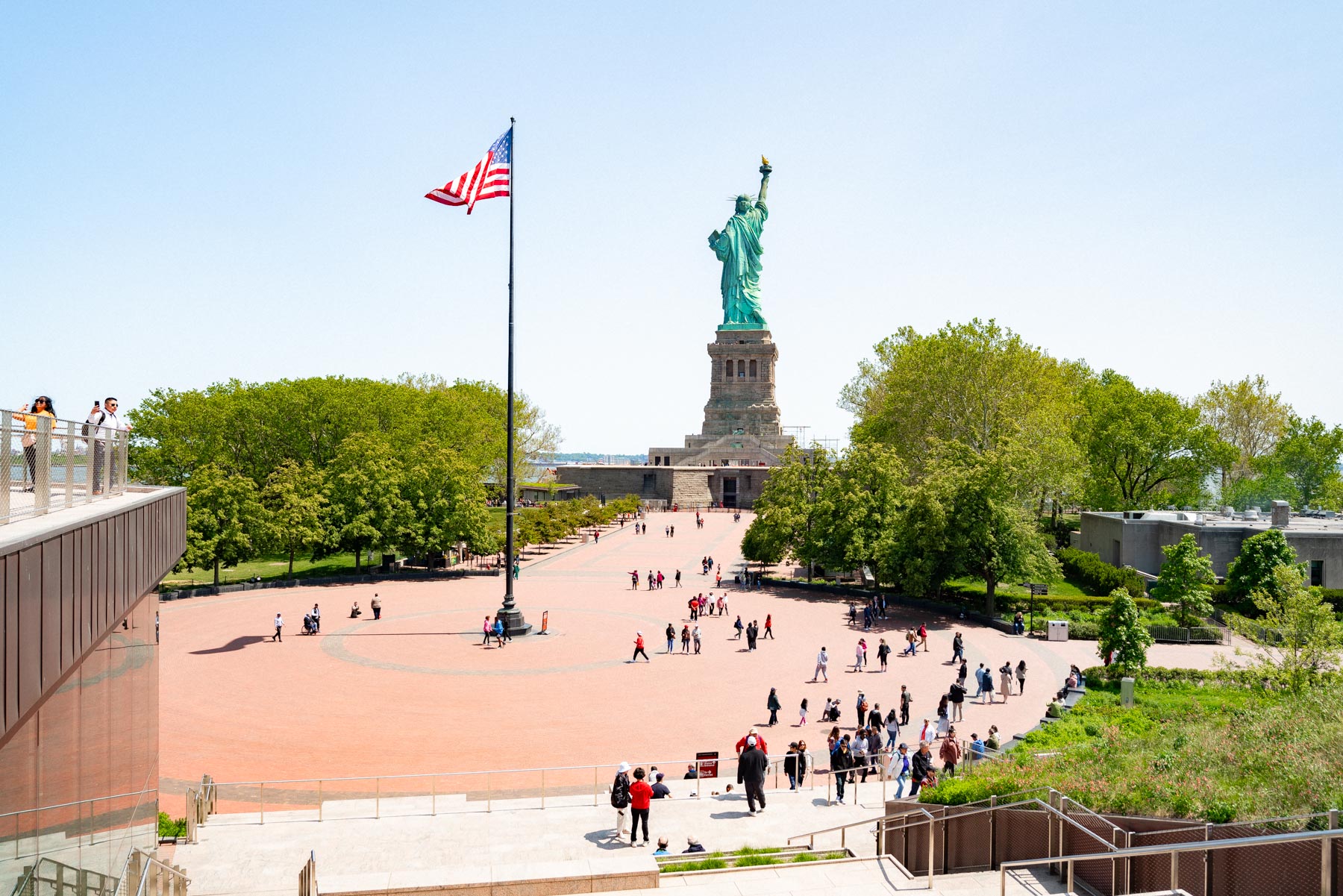 Flagpole Plaza at the statue of Liberty as seen from the museum on Liberty Island