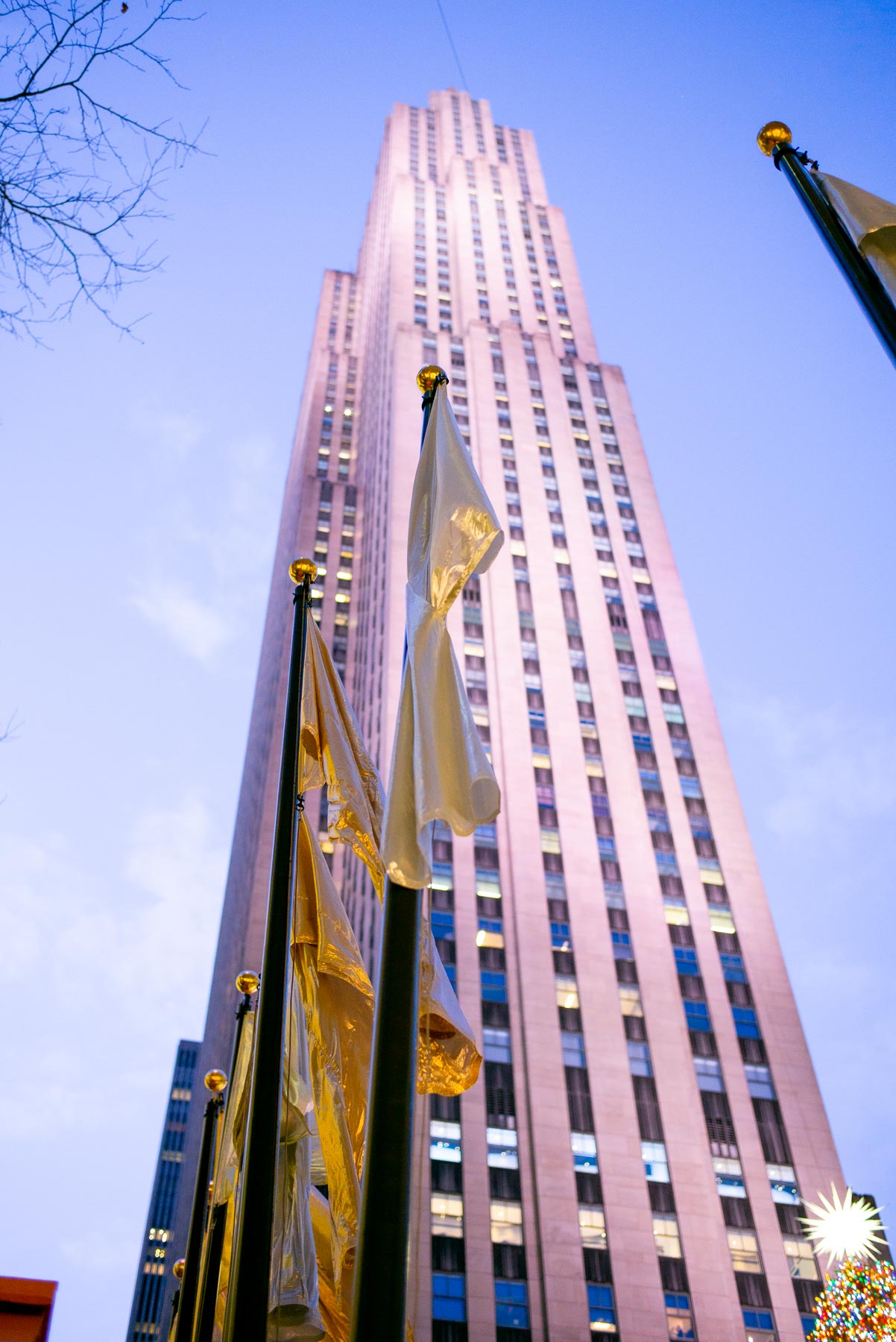 Rockefeller Plaza, 30 Rock Building with a flag pole and gold flags attached 