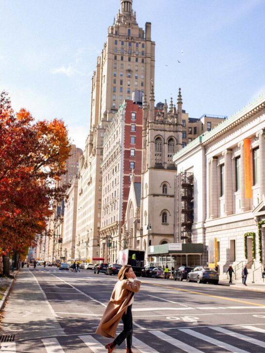 Trendy woman crossing the street on the Upper West Side wearing a brown wool coat during the fall, One of the best budget-friendly tips for living in NYC is to walk everywhere