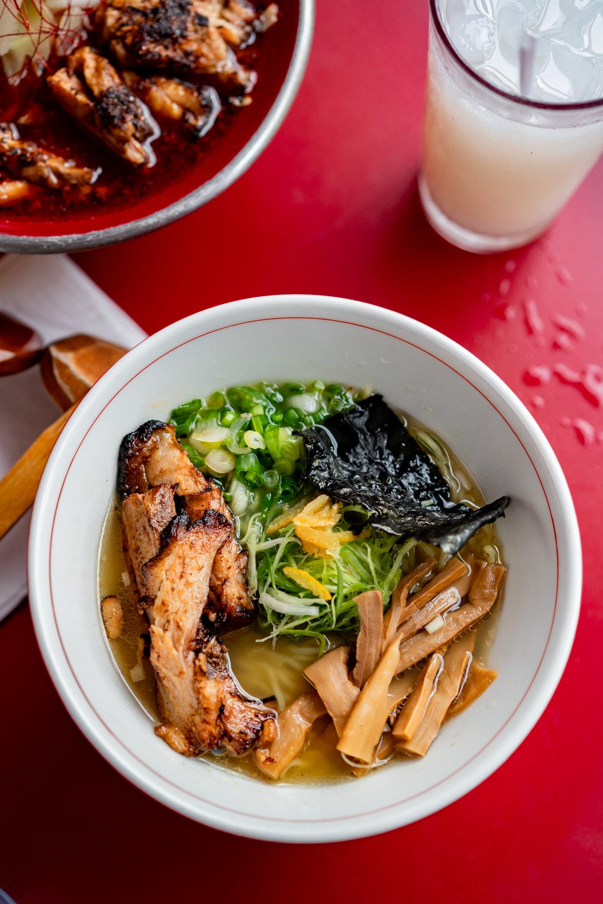 bowl of chicken ramen from Mr. Taka on a red table, best things to do in the Lower East Side