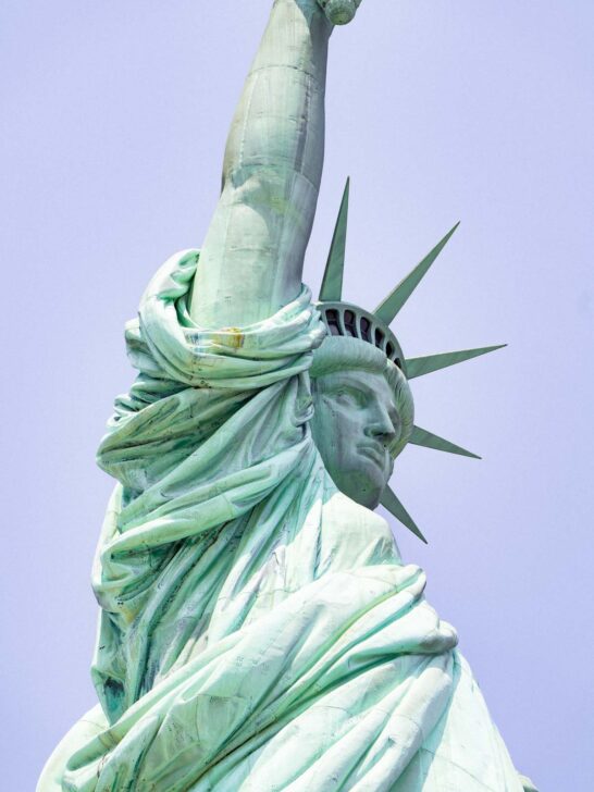 close view of the Statue of Liberty with details of the crown and face when people visit the Statue of Liberty in NYC