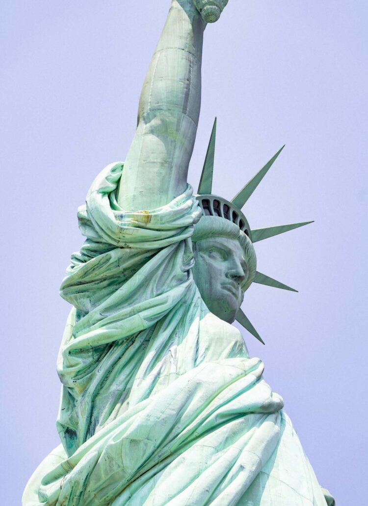 close view of the Statue of Liberty with details of the crown and face when people visit the Statue of Liberty in NYC