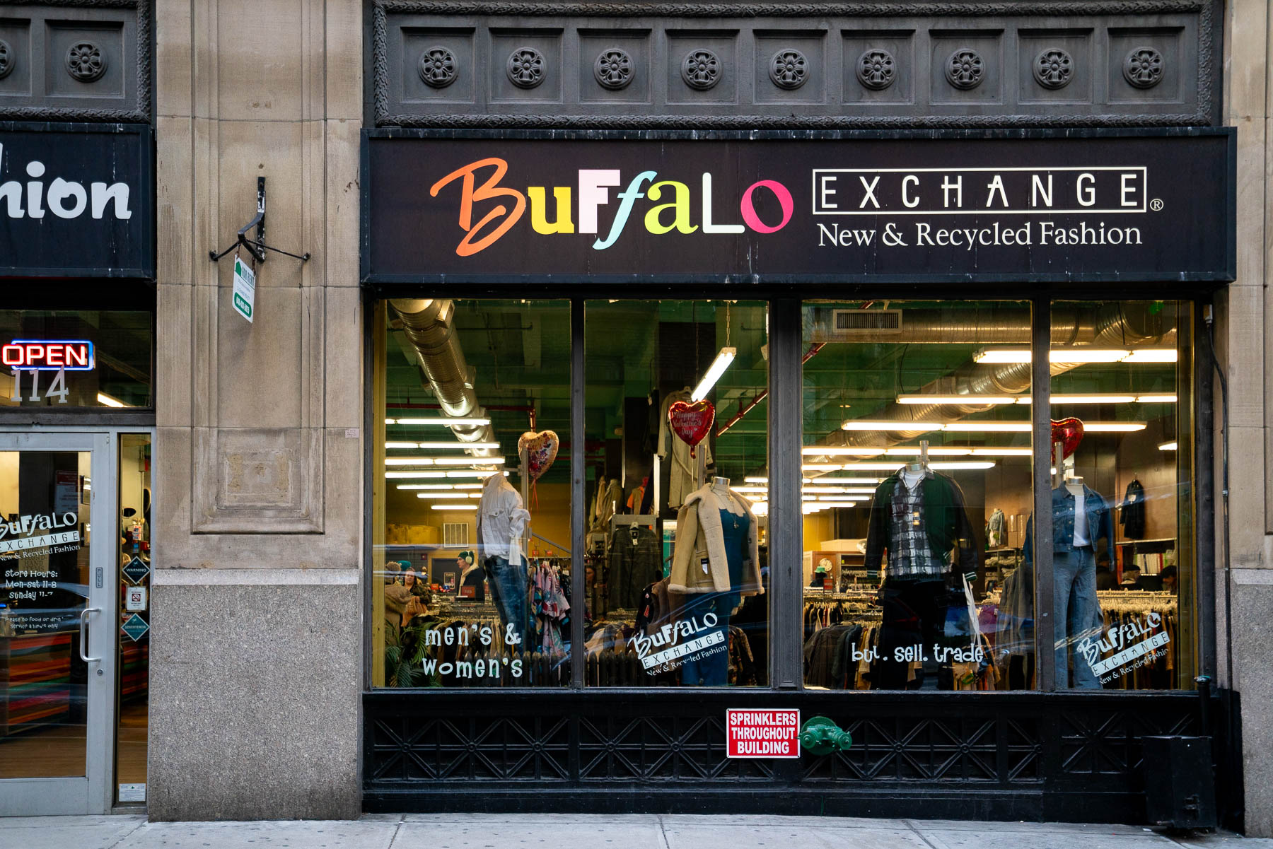 Exterior of Buffalo Exchange, one of the best thrift stores in NYC with display mannequins in its windows