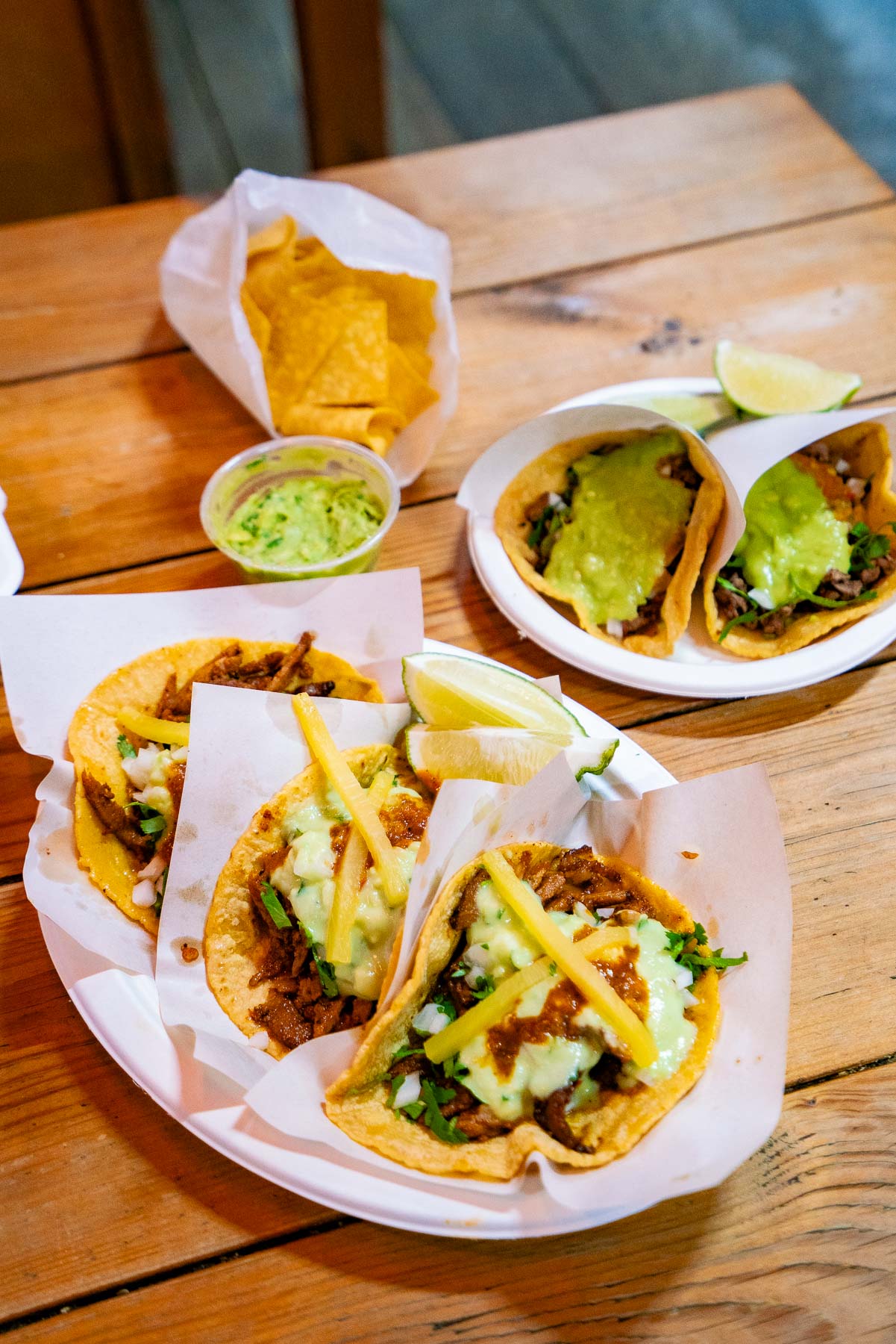 Al Pastor and Asada Tacos from Los Tacos No. 1 on an outdoor table, one of the best restaurants at the Chelsea Market