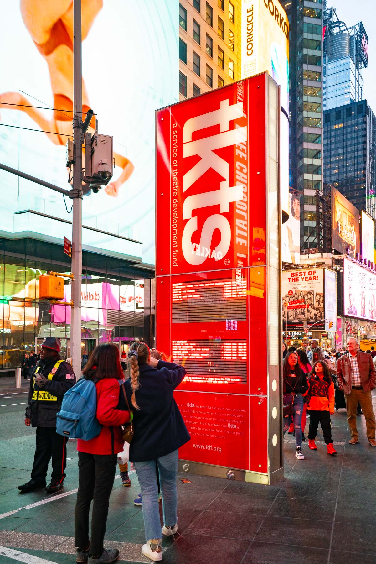 People looking over ticket pricing at the TKTS Ticket Booth in Times Square, TKTS Ticket Booth Tips and Tricks