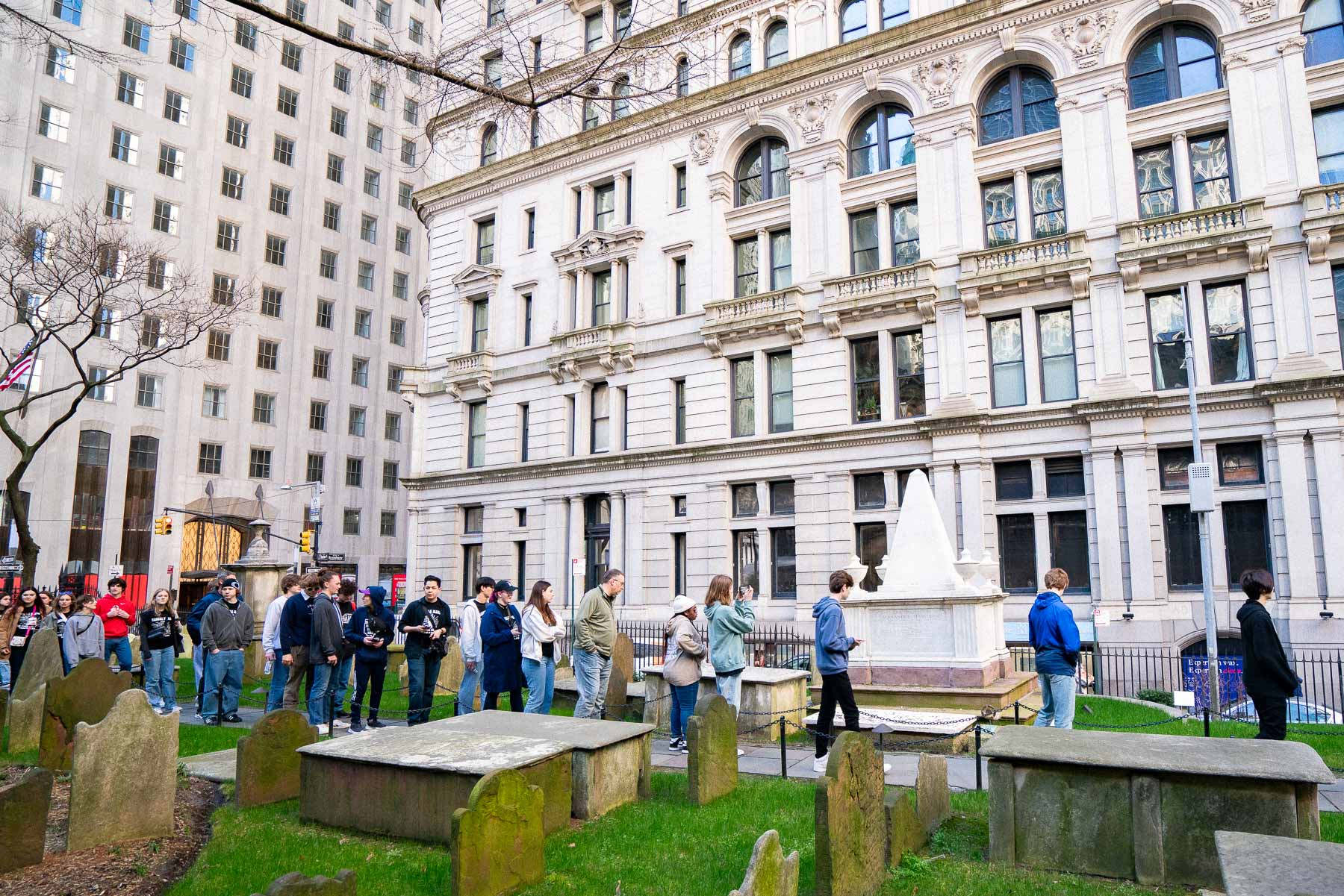 A tour lining up for photos of Alexander Hamilton's Grave in NYC