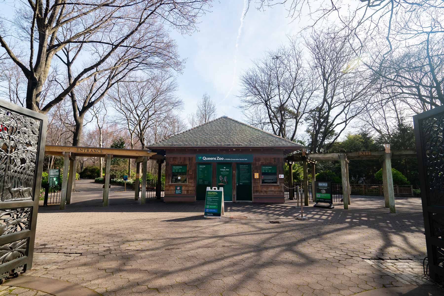 Exterior shot of the Queens Zoo ticket booth with both the entrance and exit visible from the gate