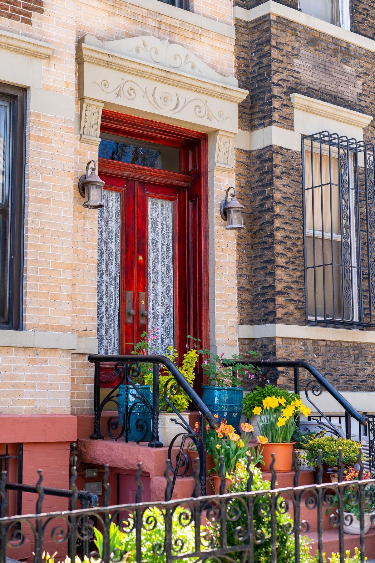 A stoop adorned with flowers and plants in Sunset Park, one of the best neighborhoods in Brooklyn