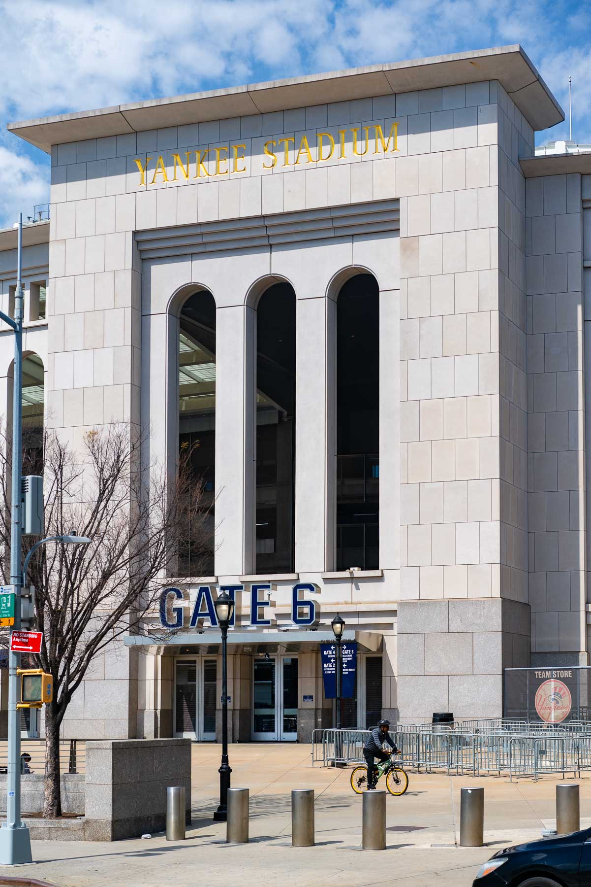 Photo of Gate 6 entrance at Yankee stadium with a man on a bike riding past